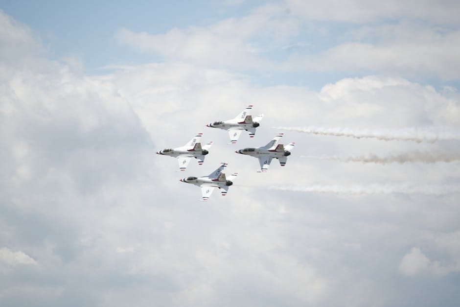 Red Arrows aerobatic display over Bournemouth beach with coloured smoke trails
