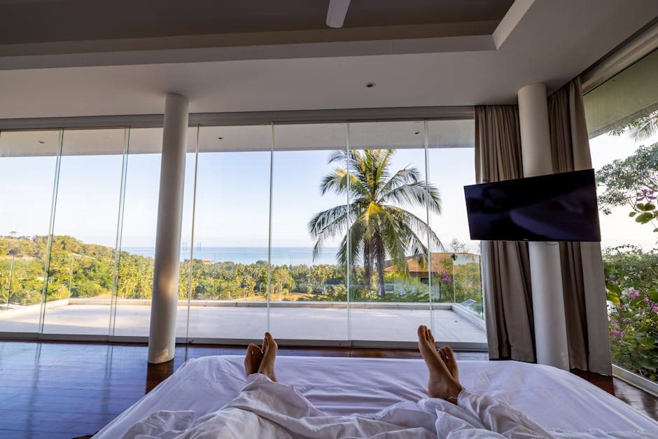 Luxury hotel room with ocean view and palm trees, representing the kind of quality apartment available for a romantic coastal stay
