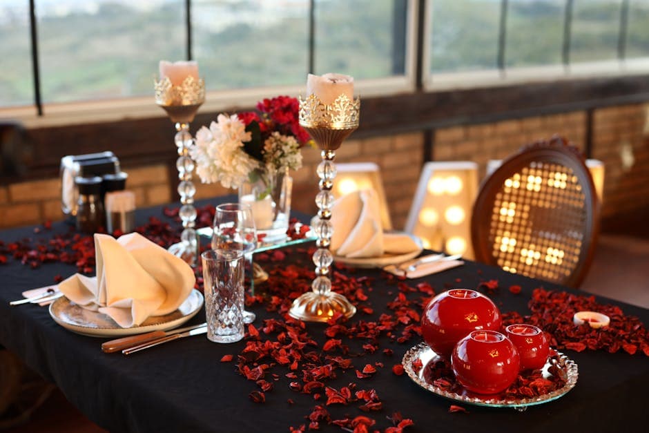 Romantically set restaurant table with red candles and elegant glassware for a special dinner
