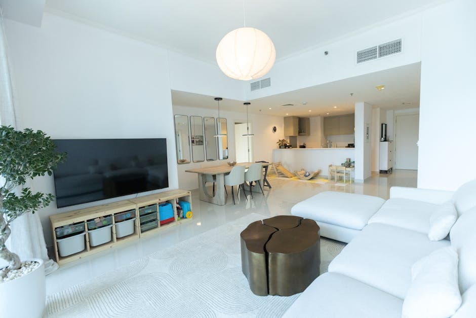 A well-appointed modern apartment interior with clean lines, comfortable furnishings, and good natural light