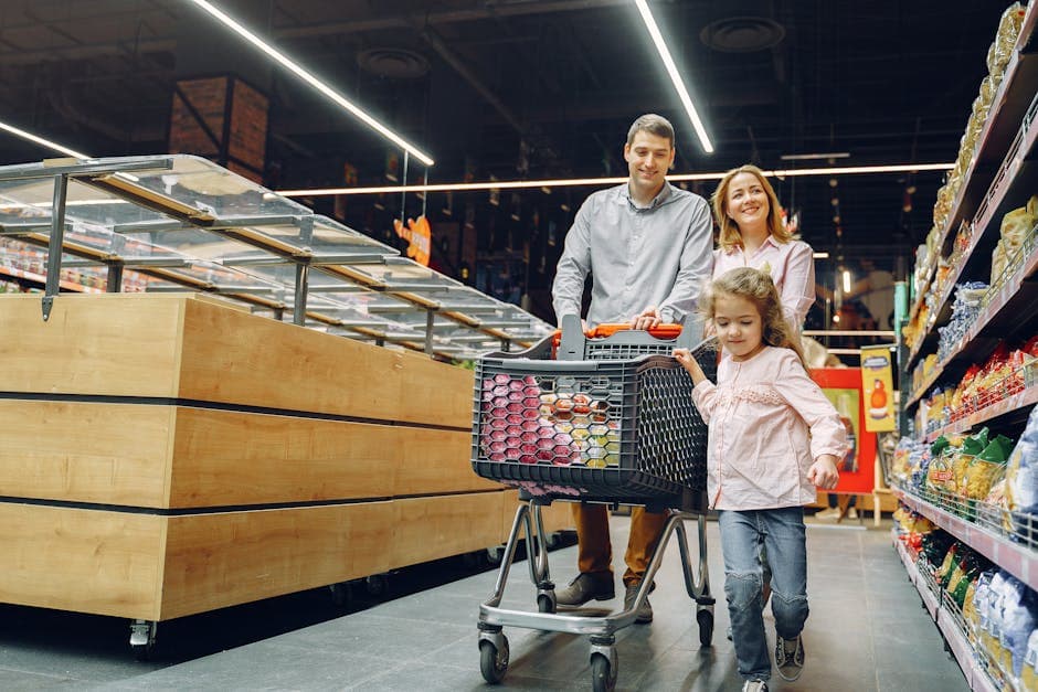 A family shopping together in a supermarket aisle, choosing groceries for a self-catering stay