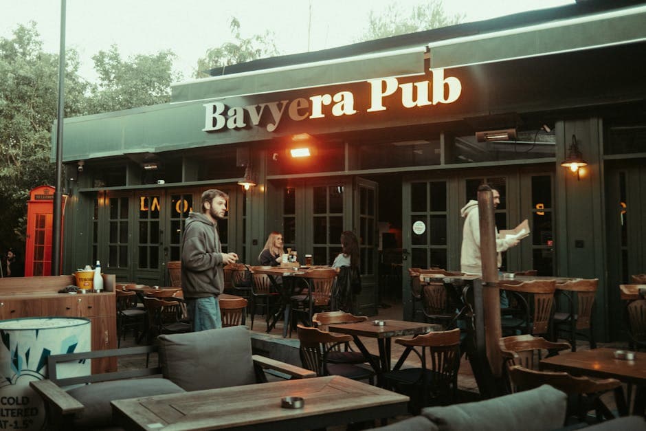 Evening outdoor seating at a bar with patrons enjoying drinks in a relaxed neighbourhood atmosphere