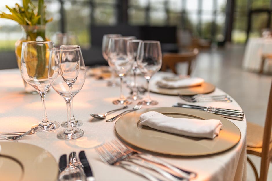Elegantly set restaurant table with wine glasses and folded napkins for an evening dining experience