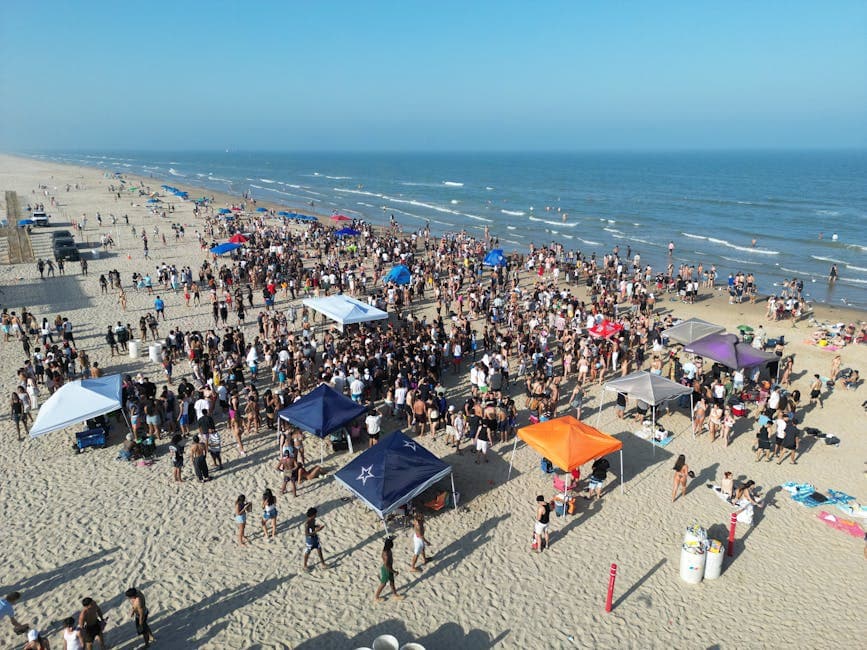 Crowds enjoying a lively beach party scene on a sunny summer day by the coast