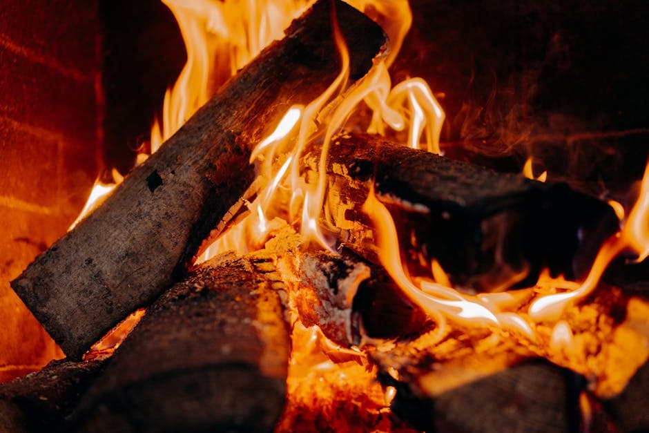 Close-up of burning logs in a fireplace creating a warm, cosy glow