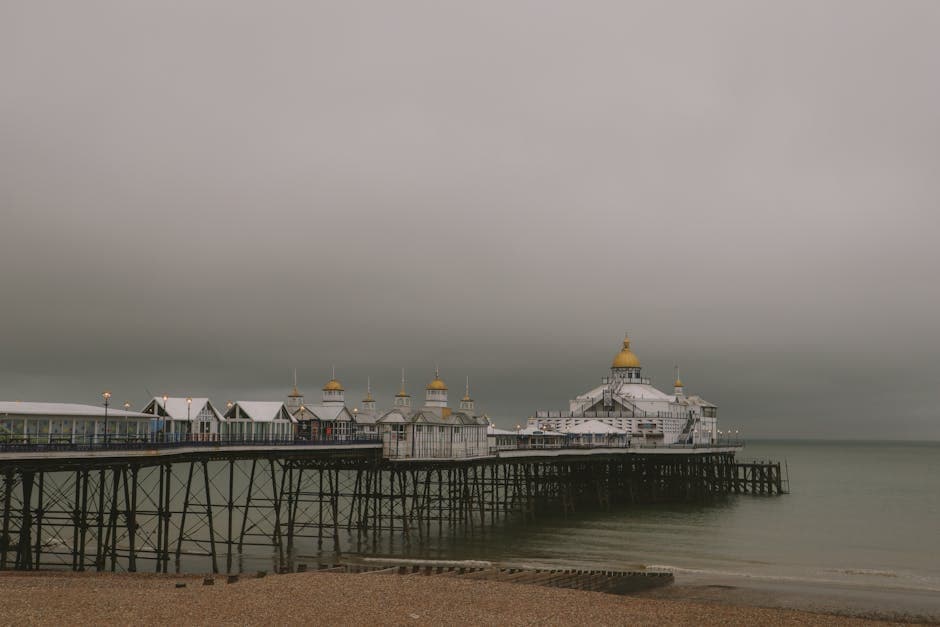 A Victorian pier extending into a calm misty sea, evoking the elegant seaside architecture of England's south coast